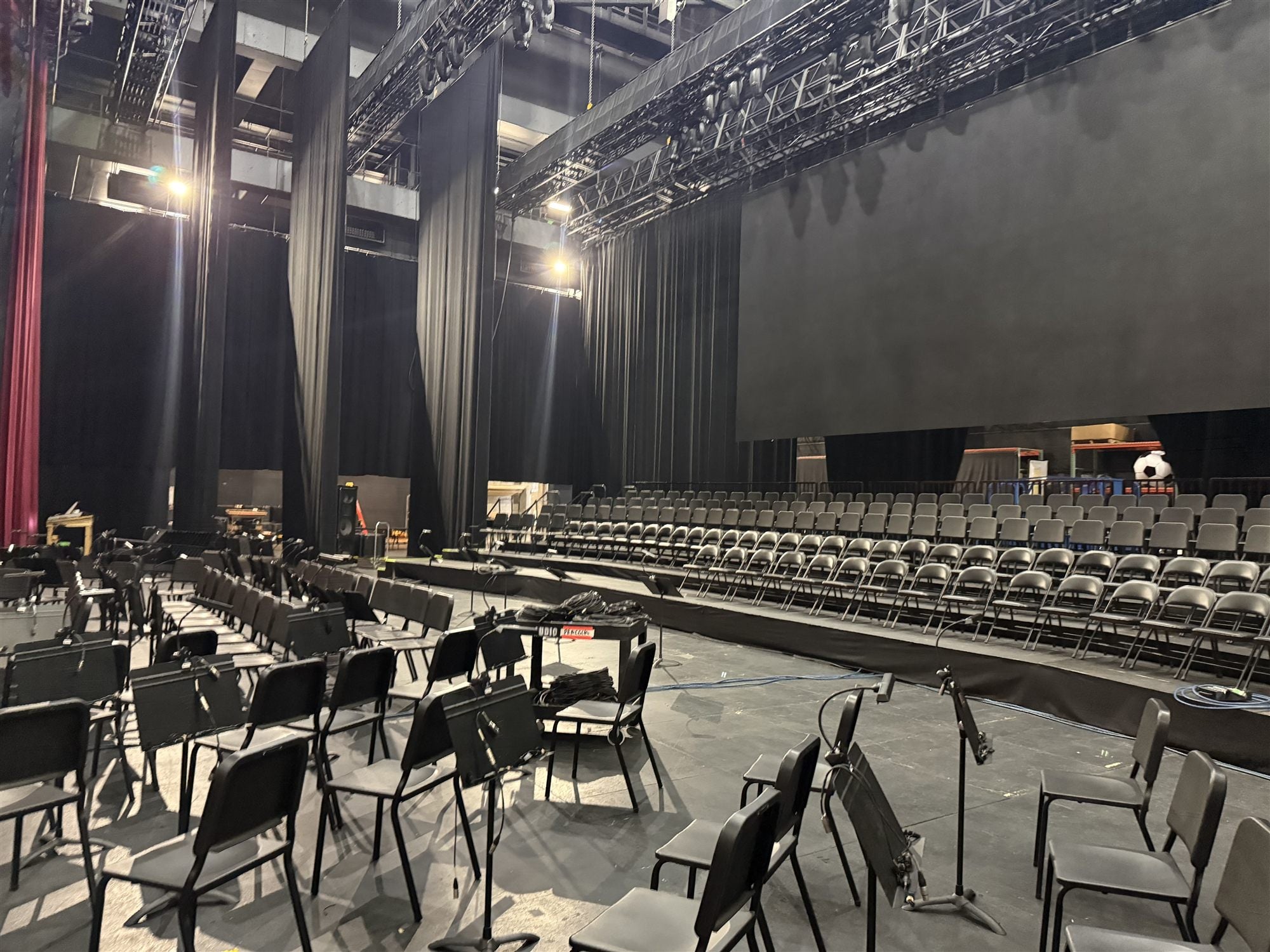 Cal Perc LA orchestra chairs and stands set across a large theater stage