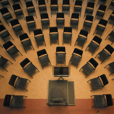 Wenger musician chairs set in orchestra arcs around a podium, seen from above