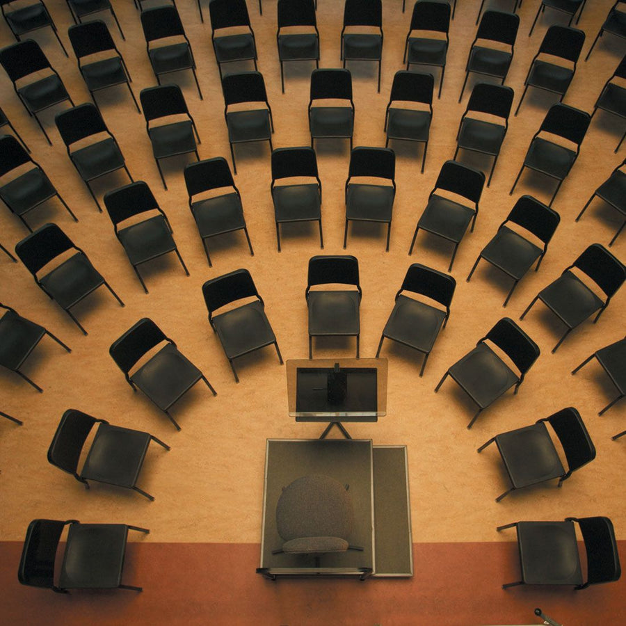 Wenger musician chairs set in orchestra arcs around a podium, seen from above