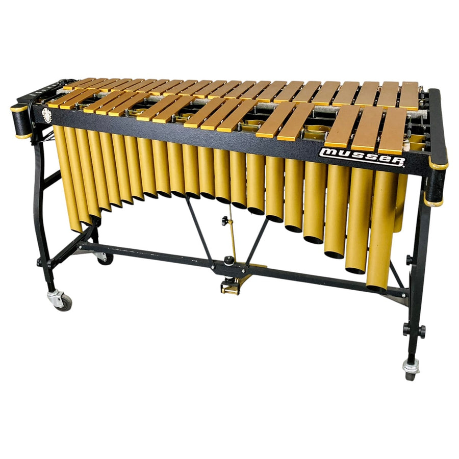 Musser M55G Pro-Vibe vibraphone with gold bars and gold resonators on a black folding frame