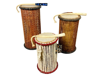 Three West African talking drums with curved beaters, woven tension cords, and shoulder straps