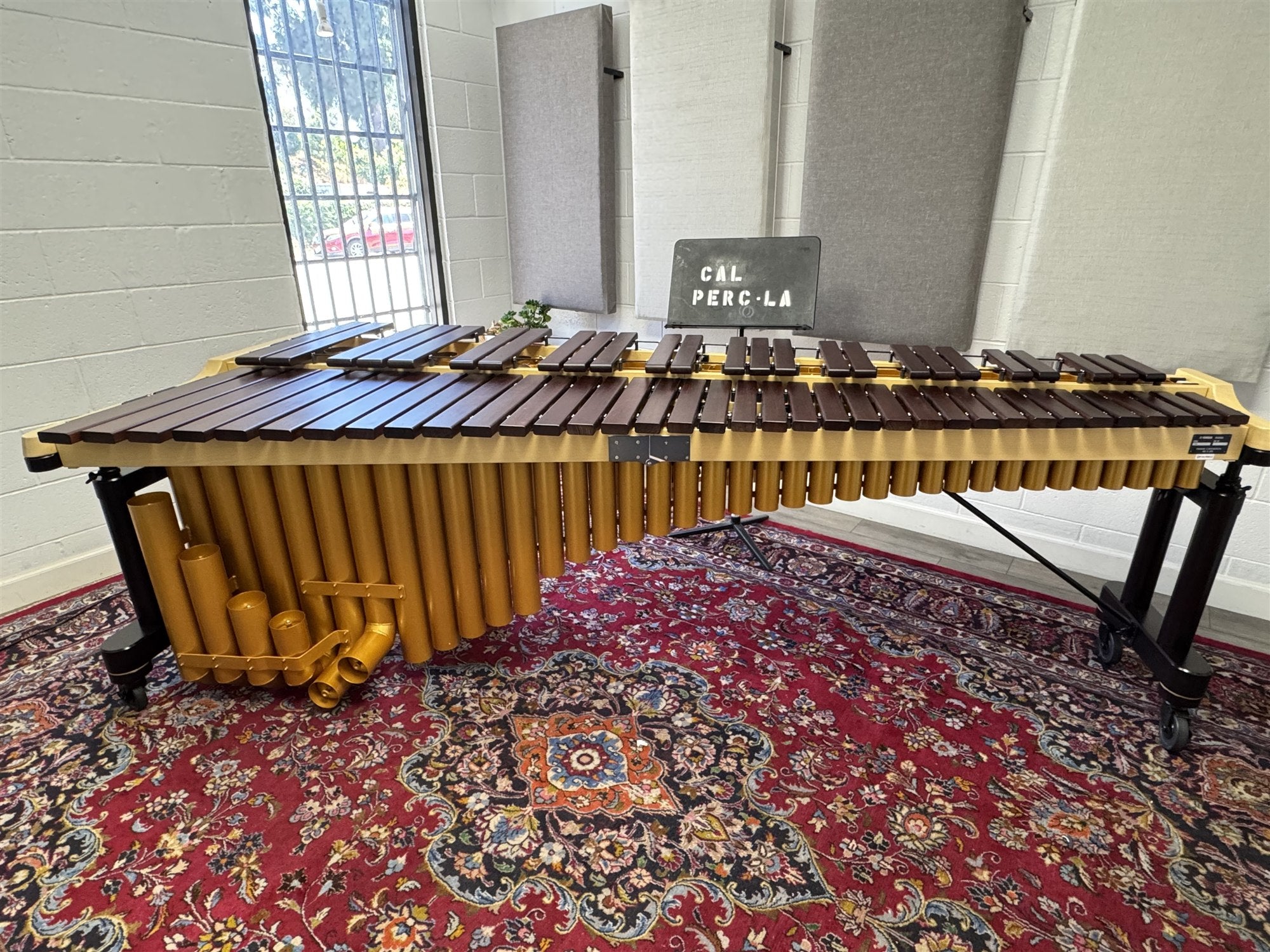 Cal Perc LA Practice Room 1 with a Yamaha five-octave rosewood marimba, acoustic wall panels, and natural light